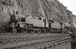 82034 - one of the three examples that survived until October 1968 - bunker to tender against an unidentifiable BR 75XXX 4-6-0.